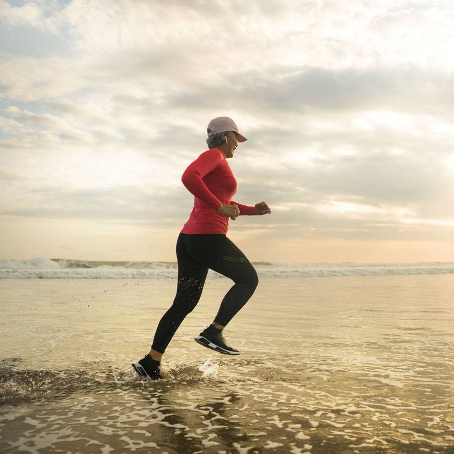 Runner on the beach at sunrise